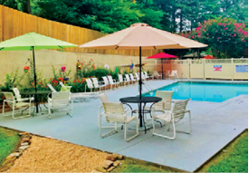 A pool table with a blue cloth and a hanging light above it. AI generated content