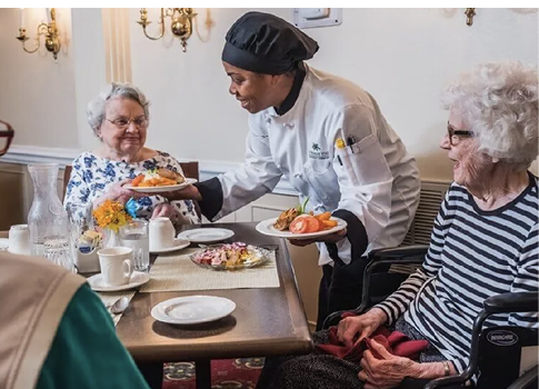 A woman in a black hat serves food to two elderly women sitting at a table. AI generated content